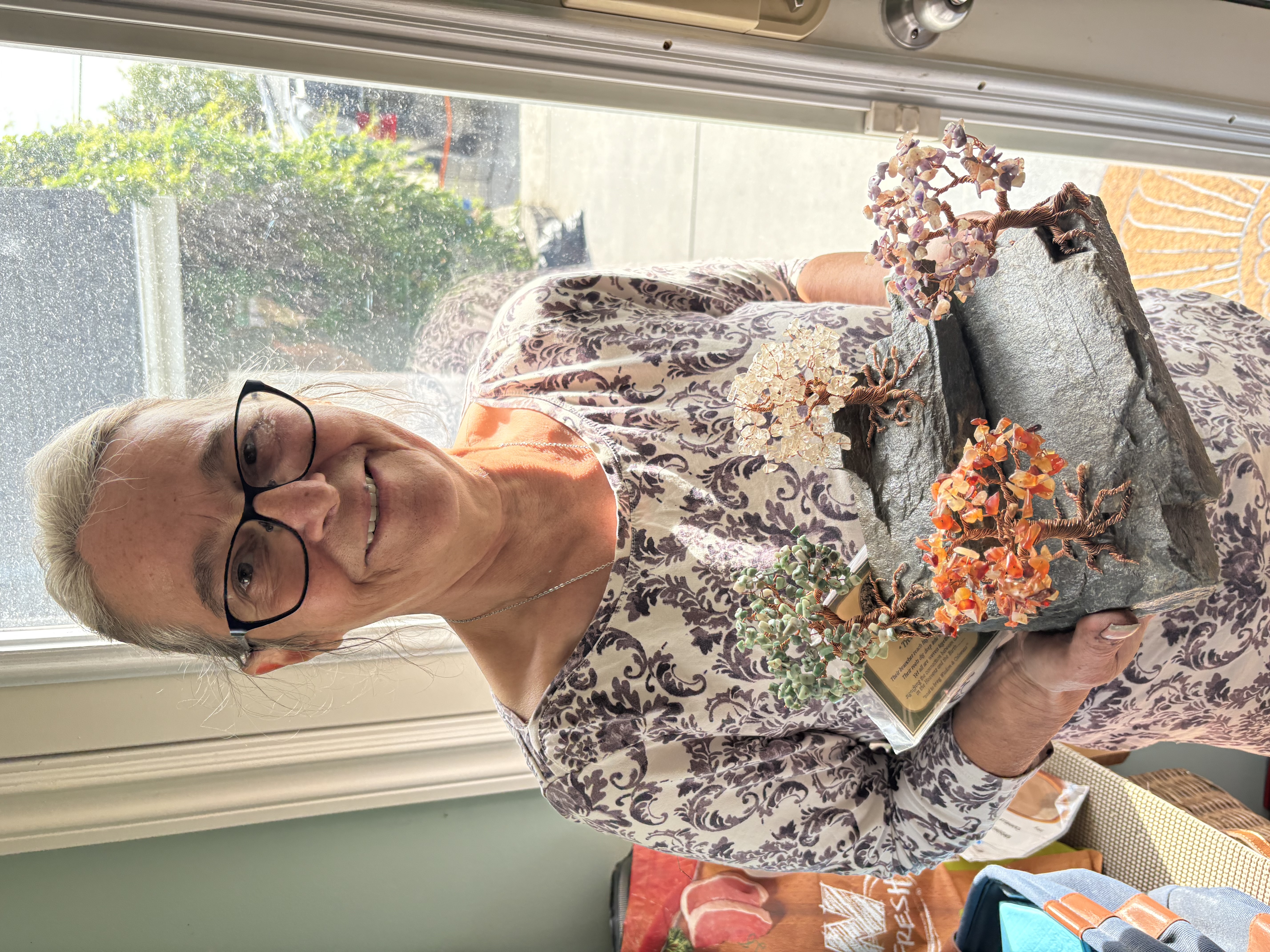 Marilyn Samuelson showcasing a Trees of Life sculpture